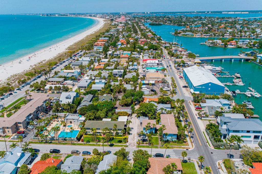 Aerial view of a beach with custom homes along the Florida barrier, showcasing coastal living and natural beauty.